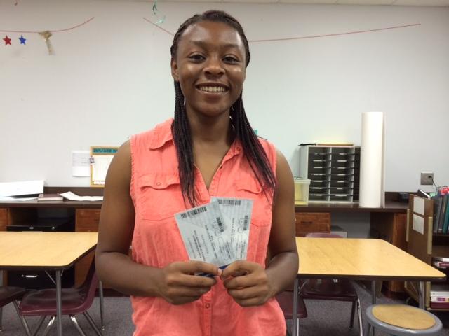 Charlene Okoye accepts her concert tickets as a prize for entering Wildcat Tales twitter contest.