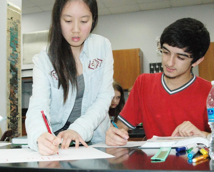 Seniors Ting-Wei Hsu and Ryan Hosein work to complete an activity about soil in Mark Yoders fourth period AP Environmental Science class. 