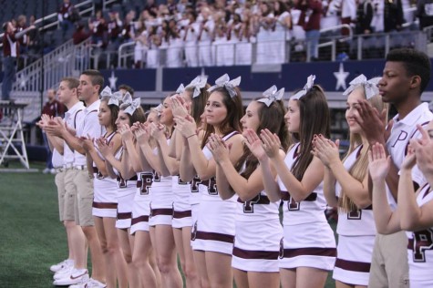 Cheerleaders clap on the sidelines during the playoff game against Denton Guyer on Nov. 15. Photo by Terry Quinn. 