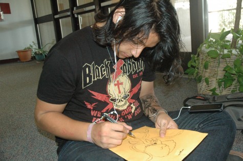 Junior Danny Barrientos draws in the library on Oct. 22. Photo by Ella Hunt. 