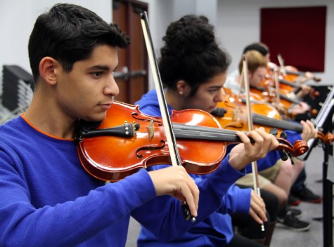 Orchestra students prepare for the upcoming concert during the month of November. Photo from yearbook archives. 