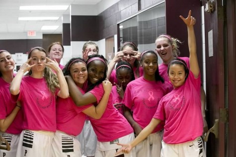 Before the game the girls basketball team poses for a team pic showing off their pink. "We were getting ready to do our pre-game cheers," Alfonso said. "Pre-game rituals are the biggest part of getting us pumped up." Photo submitted by Isabele Alfonso. 