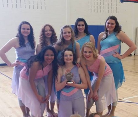 Guard members hold a trophy from their most recent contest. "We won second place at the competition," junior Erin Andereck said. "It was the Saturday after spring break so we were missing four people, unfortunately." Photo submitted by Erin Andereck.