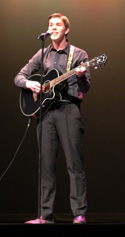 Senior Bryce Baumann strums a song for his talent portion. Photo by Kelly Jones