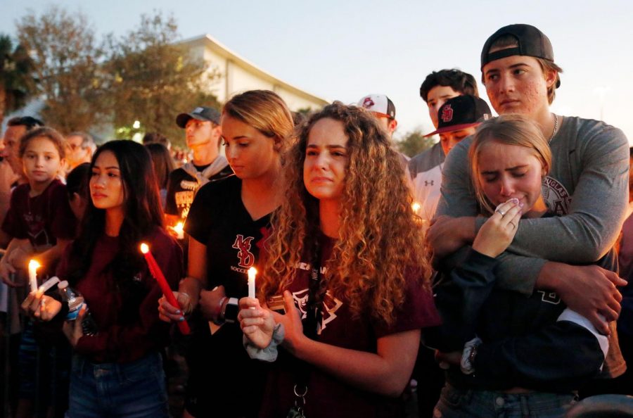 Students from Marjory Stoneman-Douglas High School pay tribute to fallen teachers and students during a candle light vigil. (photo used with permission by Getty Images)