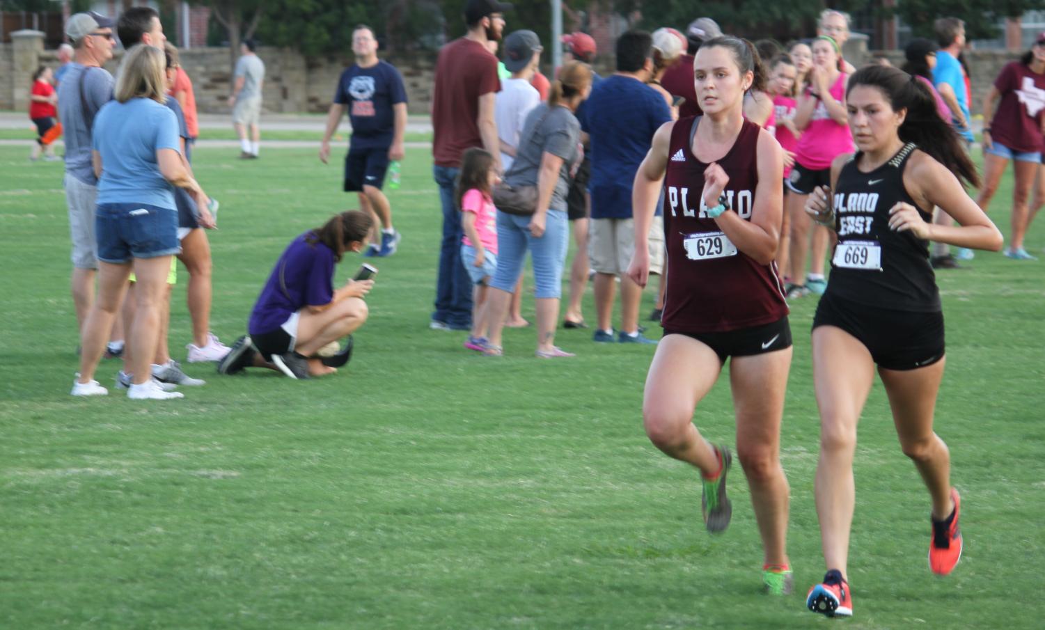 Brooke Dixon pushes herself to get past a runner for Plano East at the Plano
Invitational Cross Country meet.