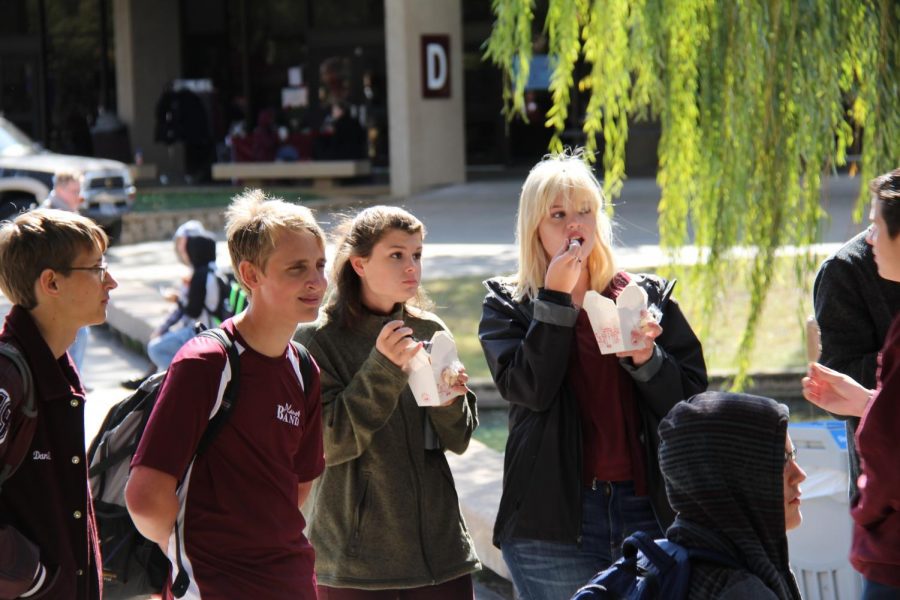 Juniors Bryan St. John, Kasi Schiffer and
Mary Campbell enjoy watching one of the
performances while eating Chinese food
during the spring Stay Day last year. (photo
by Ashley Brockette)