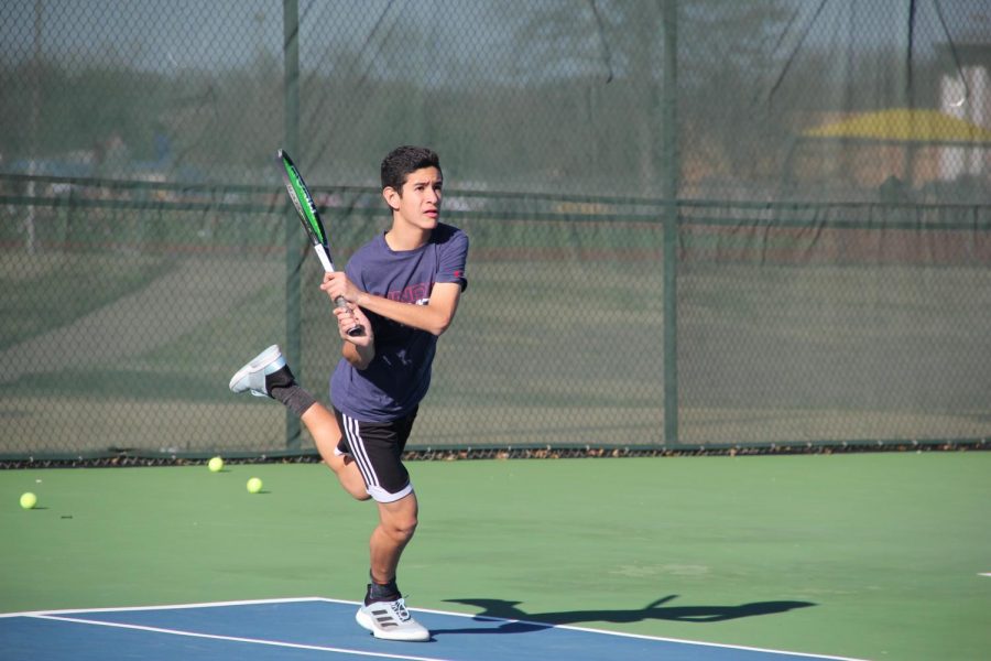 Freshman Herman Aguirre swings at Wildcat tennis court.