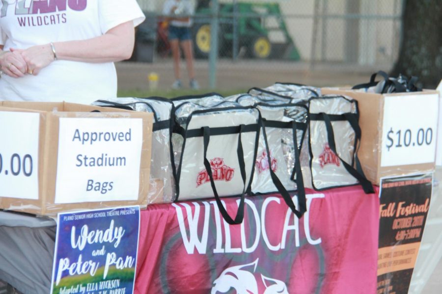 Wildcat football volunteers pass out clear bags allowed into the stadium.