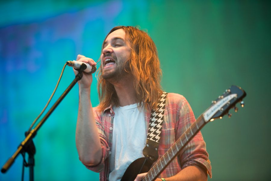 Lead singer Kevin Parker and band enamours audience at a music festival.