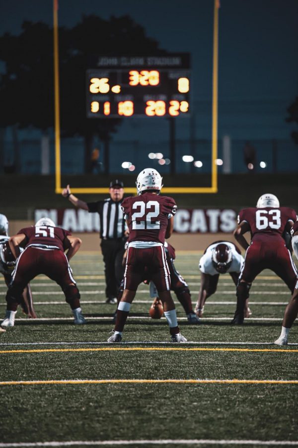 Grant Garcia (22), Jonathan Escobar (51), and Ryan Motino (63) line up at the line of scrimmage ready to snap the football into play