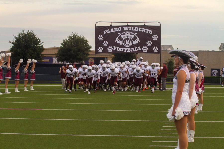 Wildcat Football Team runs onto the field before their game against Keller Central.
